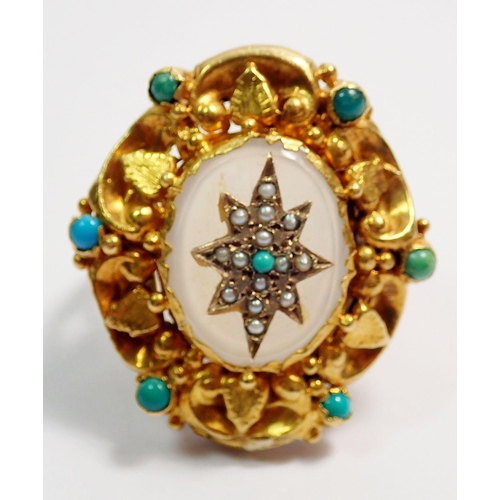 455 - An antique gold ring with white agate set seed pearl and turquoise star within ornate foliage and sc... 