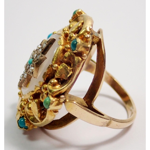 455 - An antique gold ring with white agate set seed pearl and turquoise star within ornate foliage and sc... 