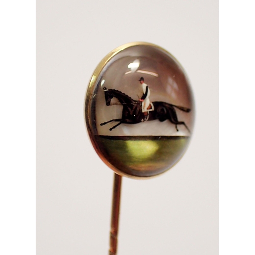 456 - An antique Essex crystal stick pin with jockey and race horse, set in 18 carat gold with original ca... 