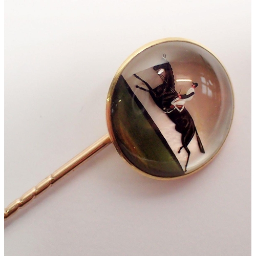 456 - An antique Essex crystal stick pin with jockey and race horse, set in 18 carat gold with original ca... 