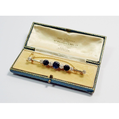 458 - A fine 15 carat gold and platinum bar brooch set three sapphires and six diamonds, 1.25 cts diamonds... 