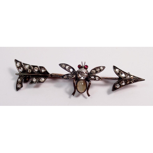 478 - An antique silver arrow form brooch with bee set old cut diamonds, moonstone body and ruby eyes, a/f... 