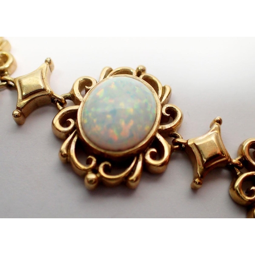 491 - A 9 carat gold opal bracelet, the seven graduated fancy scrollwork links each set an opal, 19.5cm, 2... 