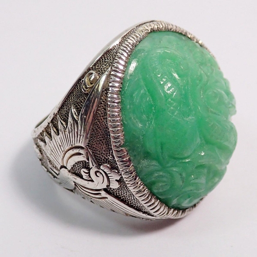 507 - A Chinese jadeite and sterling silver bracelet and matching brooch plus a similar ring, all with flo... 