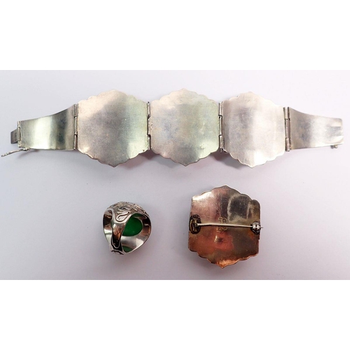 507 - A Chinese jadeite and sterling silver bracelet and matching brooch plus a similar ring, all with flo... 