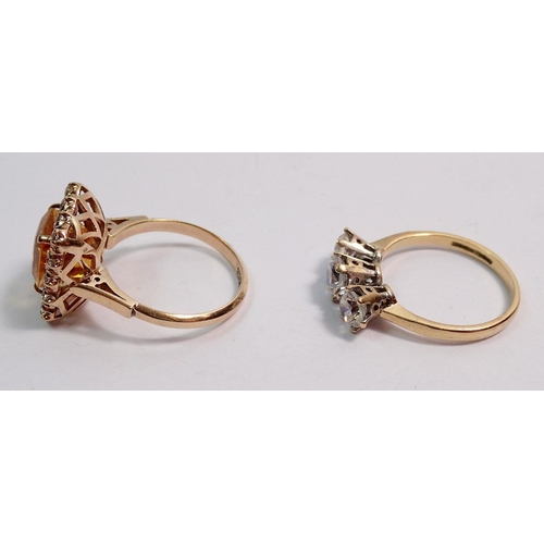 521 - A 9 carat gold yellow and white stone dress ring and a three stone 9 carat gold dress ring, total we... 