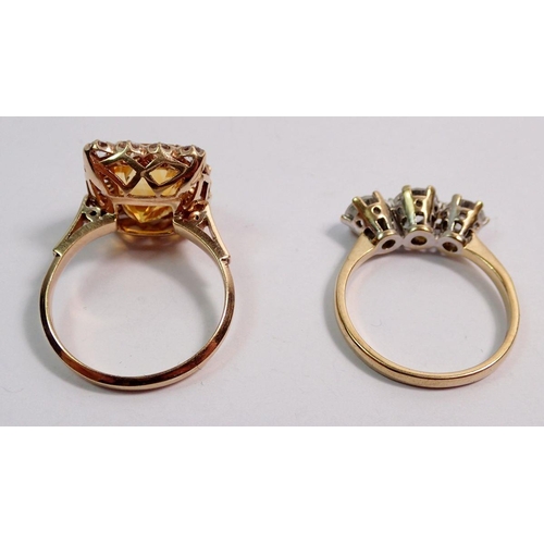 521 - A 9 carat gold yellow and white stone dress ring and a three stone 9 carat gold dress ring, total we... 