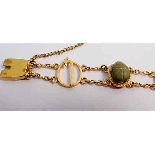 540 - An antique gold and scarab beetle bracelet with four decorative oval links and three scarabs, 19g - ... 