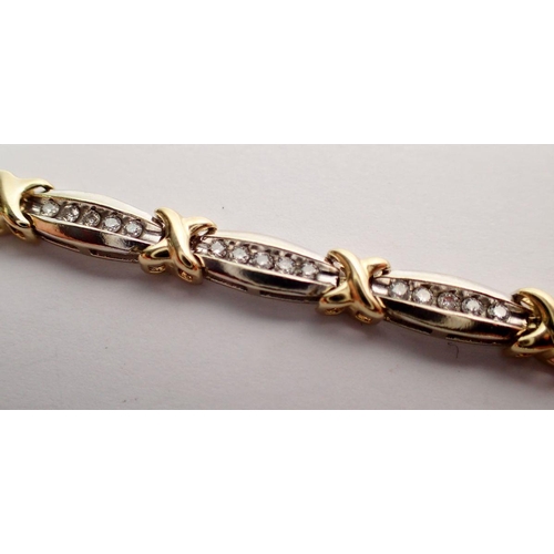 544 - A 9 carat yellow and white gold bracelet with fourteen links set seventy diamonds totaling one carat... 