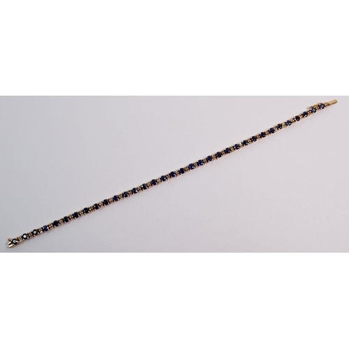 547 - A 9 carat gold sapphire and diamond tennis bracelet, 9.5g