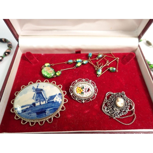 575 - A group of vintage costume jewellery including glass necklaces, Delft brooch etc.