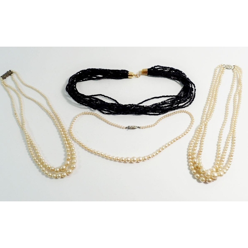 580 - Three simulated pearl necklaces and a black bead one