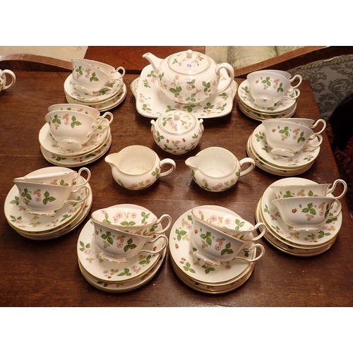 59 - A Wedgwood Wild Strawberry tea service comprising:-teapot, sixteen cups and saucers, two milk jugs, ... 