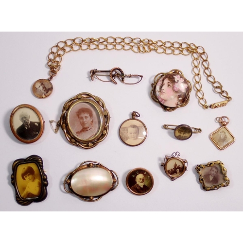 611 - A collection of photo locket brooches, mourning brooches etc including one 9 carat gold example on g... 