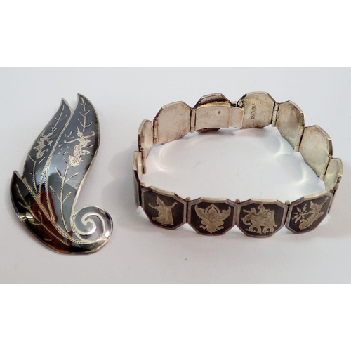 623 - A sterling silver niello bracelet 41g and a brooch, 7.5cm wide