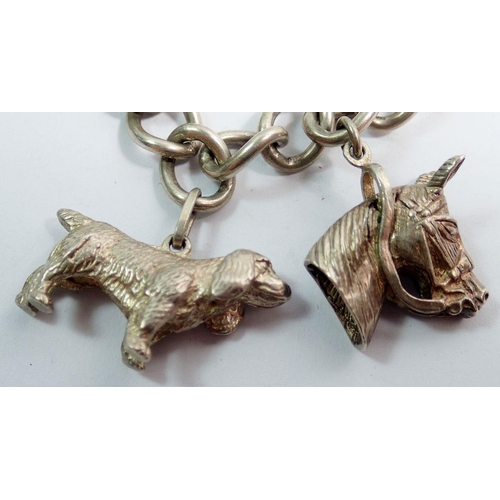 632 - A silver charm bracelet and charms including spaniel, horse etc, total weight 70g