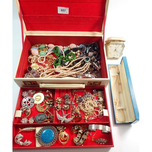 657 - A jewellery box containing various costume jewellery including necklaces, bracelets, etc.