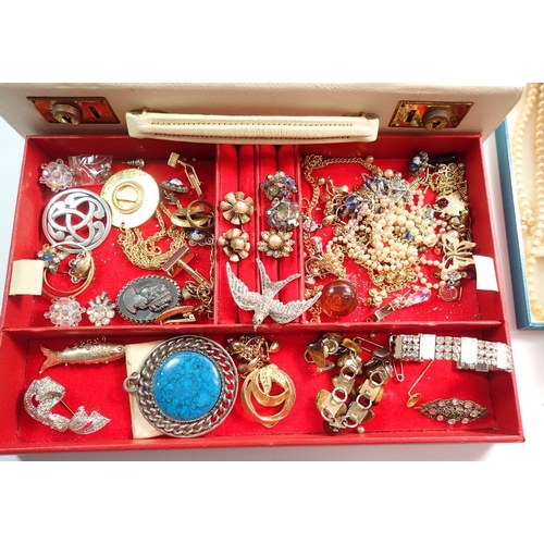 657 - A jewellery box containing various costume jewellery including necklaces, bracelets, etc.