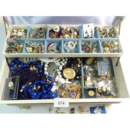 674 - A large collection of costume jewellery including necklaces, bracelets, brooches etc.