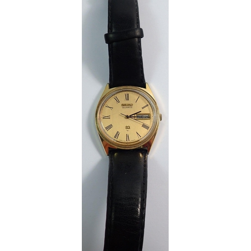 689 - A gentleman's Seiko S Q Quartz watch, gold plated case with day/date aperture on black leather strap