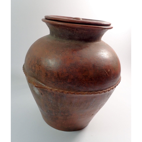 8 - A large terracotta jar and cover, 30cm tall