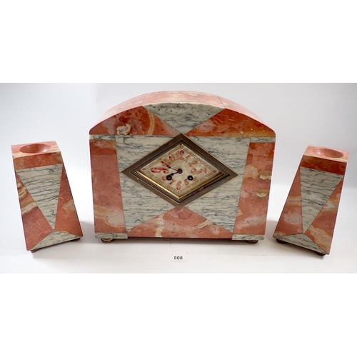 808 - An Art Deco orange and black and white marble clock garniture, clock 32cm wide x 27cm tall