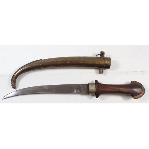 810 - An Eastern dagger with curved blade and decorative brass and white metal sheath, 40cm long