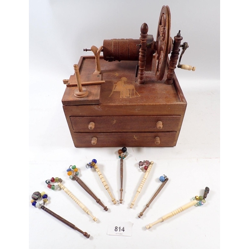 814 - An antique treen lace bobbin winder on drawer base, 22cm wide and contents of eight wood and bone tu... 