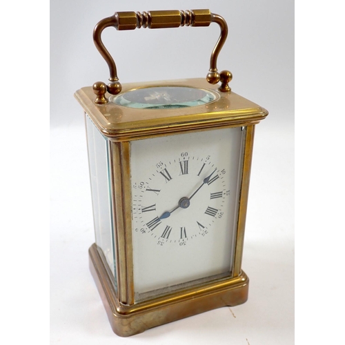 827 - A brass carriage clock, 11cm tall, rear glass panel a/f