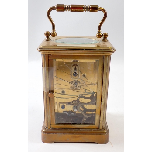 827 - A brass carriage clock, 11cm tall, rear glass panel a/f