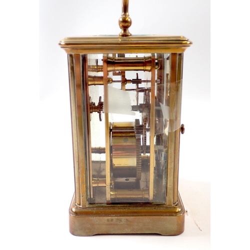 827 - A brass carriage clock, 11cm tall, rear glass panel a/f