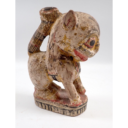 833 - A South American painted and carved wooden lion, 15.5cm tall