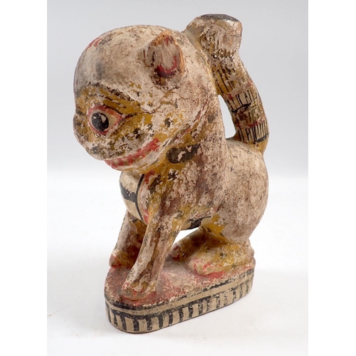 833 - A South American painted and carved wooden lion, 15.5cm tall