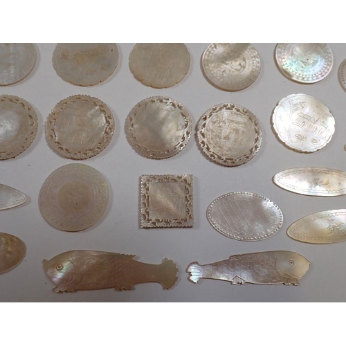 837 - A collection of over 50 mother of pearl Chinese engraved gaming tokens including fish examples