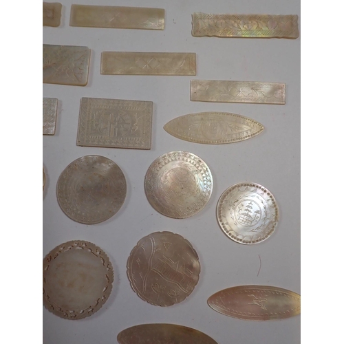 837 - A collection of over 50 mother of pearl Chinese engraved gaming tokens including fish examples