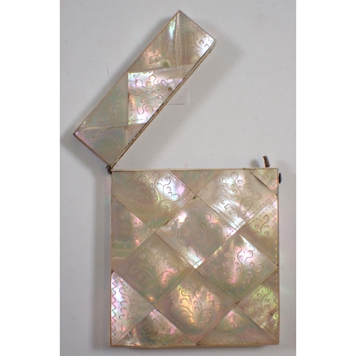 842 - A Victorian mother of pearl card case with engraved decoration