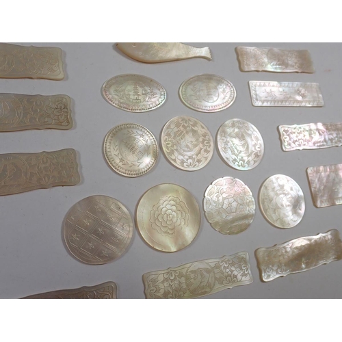 843 - Twenty one Chinese mother of pearl gaming tokens, engraved