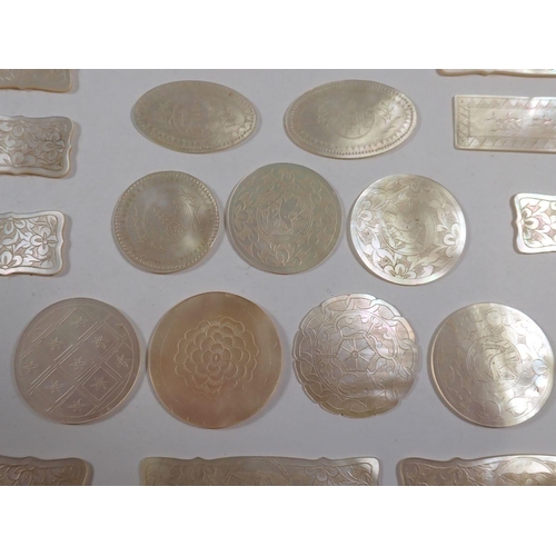 843 - Twenty one Chinese mother of pearl gaming tokens, engraved