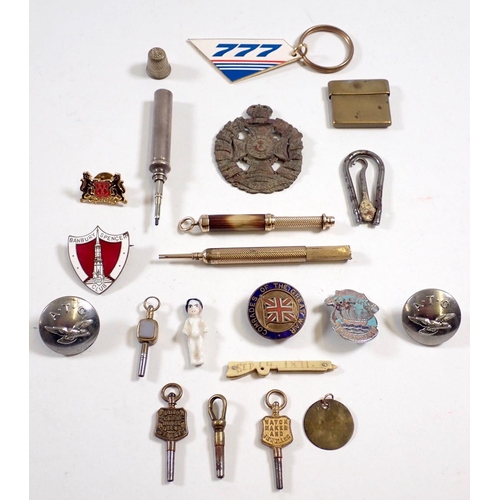 853 - A box of small collectables including badges, watch keys, pencils etc.