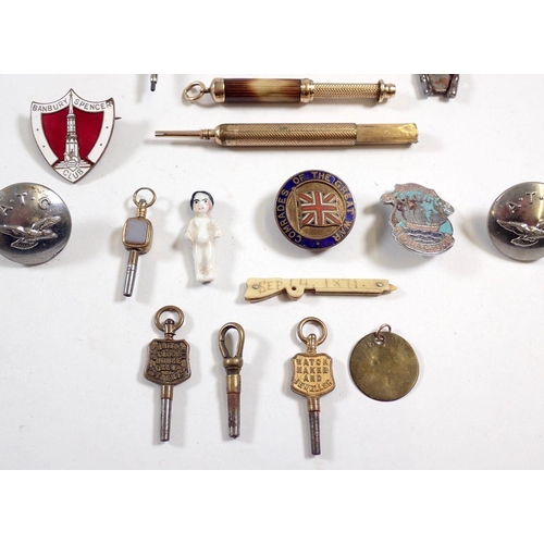 853 - A box of small collectables including badges, watch keys, pencils etc.