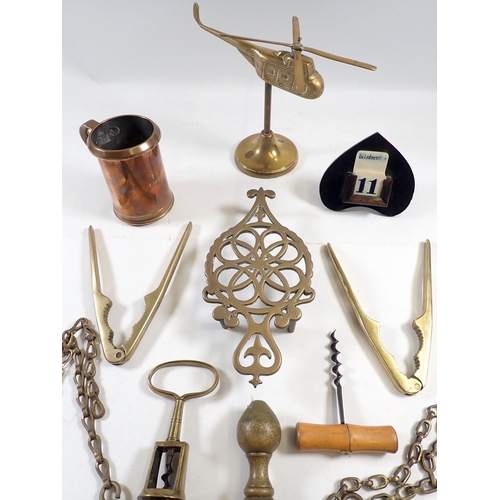 875 - A brass 1/2 pint measure and various other brass and collectables including corkscrews etc.