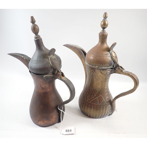 884 - Two Middle Eastern brass dallahs/coffee pots, 30cm tall