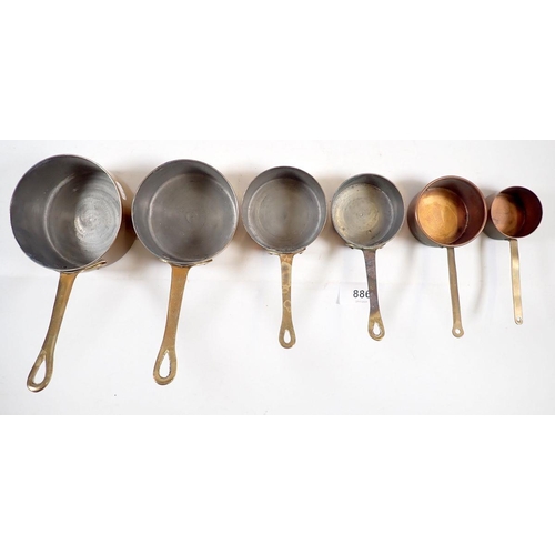 886 - A small set of copper saucepans, largest 9.5cm diameter