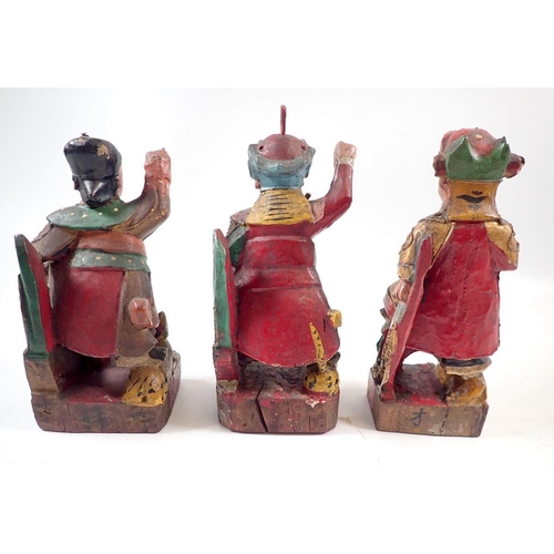 888 - A set of three Eastern polychrome carved wood figures of deitys with animals, 16cm