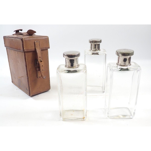 893 - A set of three gentlemen's toiletry bottles in leather case