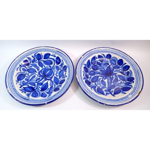 94 - A pair of continental blue and white tin glazed plates, 34.5cm diameter