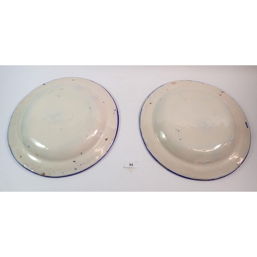 94 - A pair of continental blue and white tin glazed plates, 34.5cm diameter