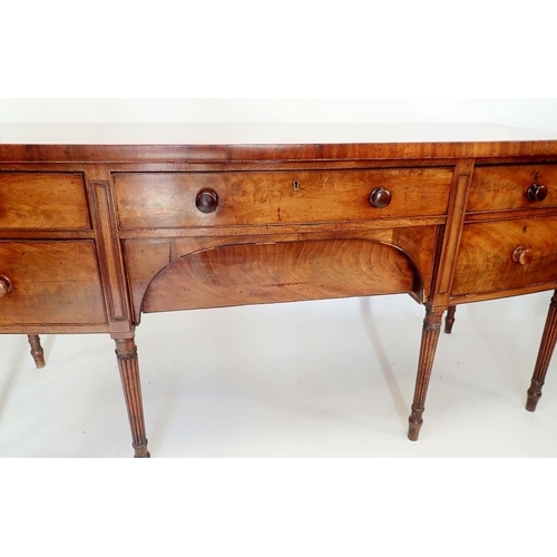 952 - A George III large mahogany bow fronted sideboard with frieze drawer and curved apron drawer flanked... 