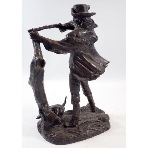 953 - A bronze study of a North American hunter with rifle and bison skull to base, 25cm tall