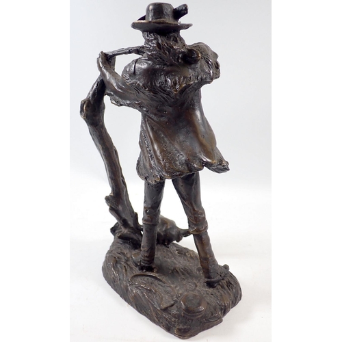 953 - A bronze study of a North American hunter with rifle and bison skull to base, 25cm tall